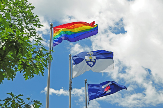 The Pride flag, U of T flag, and Varsity flag